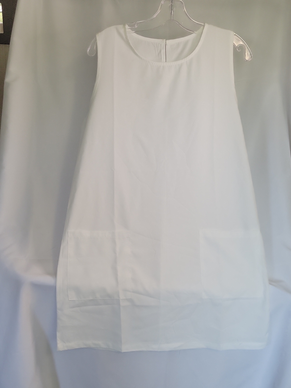 Sleeveless White Shift Dress with Front Patch Pockets